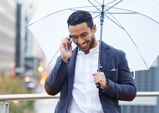 Wiley-Insurance-business-man-walking-with-umbrella