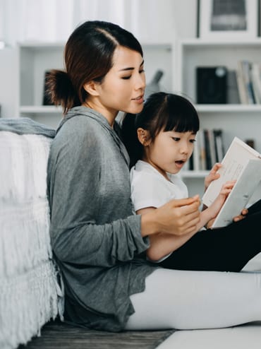 Wiley Insurance Services | Rock Hill, SC | mother with daughter reading book on bedroom floor
