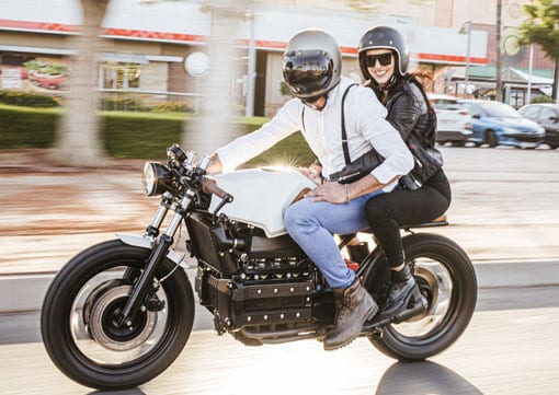 Wiley Insurance Services | Rock Hill, SC | couple riding a motorcycle past a plaza