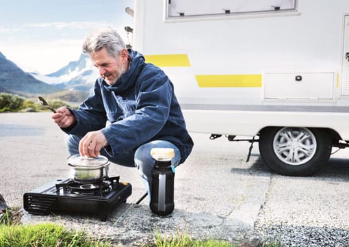 Wiley Insurance Services | Rock Hill, SC | older man on side of road with his RV cooking food