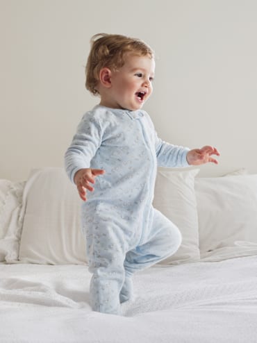 Wiley Insurance Services | Rock Hill, SC | smiling baby jumping on bed